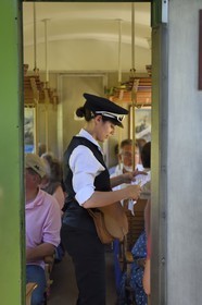 France, Alpes de Haute Provence, between Annot and Saint-Benoit, tickets control by Lucile Isnard aboard a passenger car of the Train des Pignes historic train