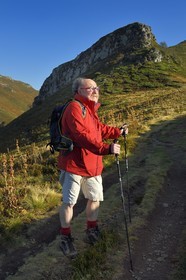France, Cantal, Parc Naturel Régional des Volcans d'Auvergne (regional nature park of Auvergne volcanoes), Le Lioran, col de Rombiere, Bernard Quinsat who imagined the Via Arverna in the 2000s on the way to Saint Jacques de Compostela and founder of the guide publishing house Chamina, the col de Cabre and the Puy Bataillouse in the background