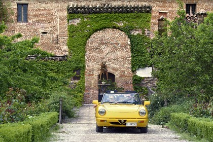 Italy, Emilia Romagna, Polesine Zibello near Parma, Antica Corte Pallavicina Hotel and restaurant, Alfa Romeo Duetto Spider yellow cabriolet