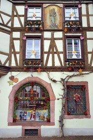 France, Haut Rhin, Strasbourg, Kaysersberg, half-timbered house of the Loewert bakery with a painting of the Virgin and Child on the facade and Christmas decorations
