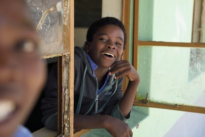 Namibia, Erongo region, Damaraland, the Spitzkoppe in the Namib Desert, Katora Primary School, boy in the grade 4 classroom (around 11 years)