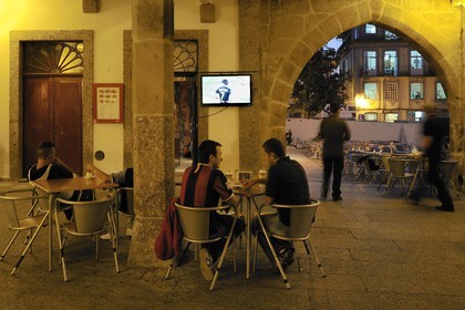 Portugal, Minho region, Guimaraes, town listed as World Heritage by UNESCO, cafe terrace under the former City Hall between the Largo da Oliveira and the Santiago square