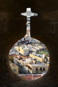 Spain, Andalusia, Almeria, view of the Medina neighborhood in the old city through a Alcazaba fortress loophole