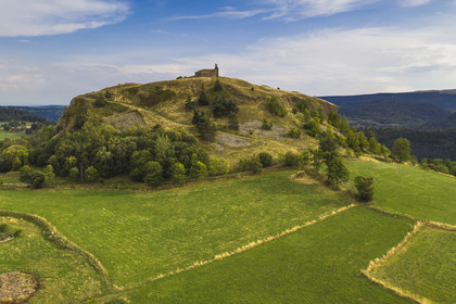 France, Cantal, Parc Naturel Régional des Volcans d'Auvergne (regional nature park of Auvergne volcanoes), Chastel-sur-Murat, 12th century perched on a promontory Saint Antoine (Saint Anthony) Chapel, hickers on the Way of St. James to Santiago de Compostela by Via Arverna (aerial view)