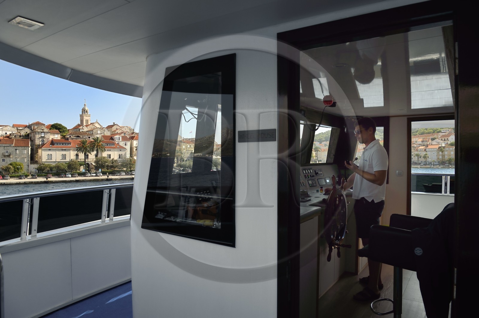 Croatia, Dalmatia, Dalmatian coast, Korcula Island, Korcula Town, arrival at the port of cruise ship Ave Maria, its captain Rade Naranca in the wheelhouse