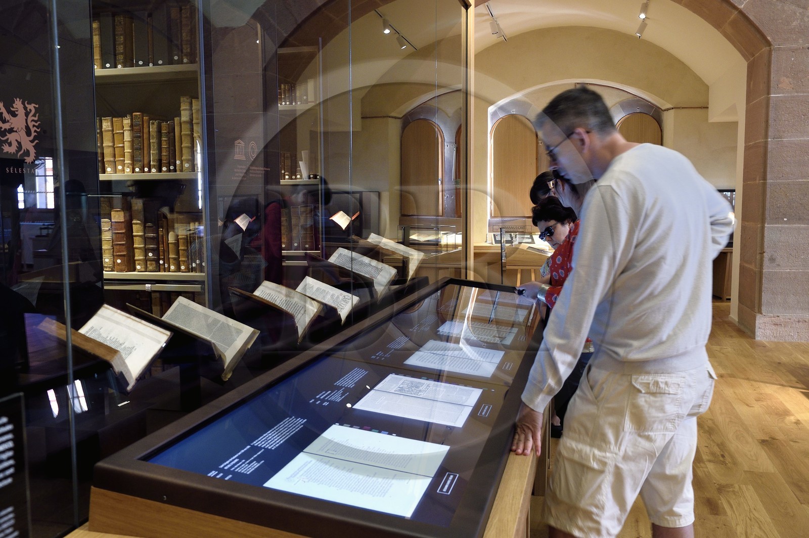 France, Bas-Rhin (67), Selestat, la Bibliothèque humaniste réaménagée par l'architecte Rudy Ricciotti, lecture en numérique des livres présentés à l'arrière des écrans, la bibliothèque personnelle de Beatus Rhenanus (1485-1547) est en arrière plan dans la pièce vitrée France, Bas-Rhin (67), Selestat, la Bibliothèque humaniste réaménagée par l'architecte Rudy Ricciotti, lecture en numérique des livres présentés à l'arrière des écrans, la bibliothèque personnelle de Beatus Rhenanus (1485-1547) est en arrière plan dans la pièce vitrée