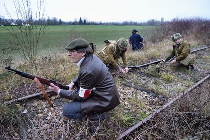 France, Eure, Cocherel, Allied Reconstitution Group (US World War 2 and french Maquis historical reconstruction Association), reenactors playing the role of British soldiers preparing to sabotage a railroad track using a plastic explosive loaf under the vigilance of partisans of the French Forces Interior (FFI)