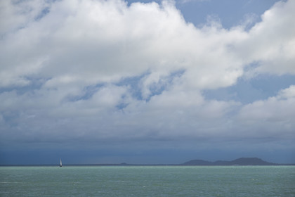 France, French Guiana, Kourou, Salvation Islands (Iles du Salut), Royal Island, catamaran off the coast of the Iles du Salut in threatening weather
