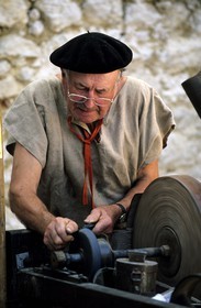 France, Gers, knife grinder, ancient job show at the medieval festival in Sarrant village, labelled Les Plus Beaux Villages de France (The Most Beautiful Villages of France)