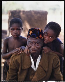 Burkina Faso, Poni province, Lobi land, Loropéni, veteran of the French army in military coat and two of his little sons
