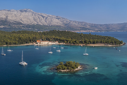 Croatia, Dalmatia, Dalmatian coast, Korcula Island, former Franciscan monastery on Badija Island in front of the Island of Korcula in the Skoji archipelago (aerial view)