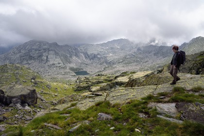 France, Alpes-Maritimes, parc national du Mercantour (Mercantour National Park), the Vallee des Merveilles (Valley of Wonders) towards the Pas de l'Arpette (Arpette pass), the archaeologist Nicoletta Bianchi overlooking the lac de l'Huile (Lake Oil)