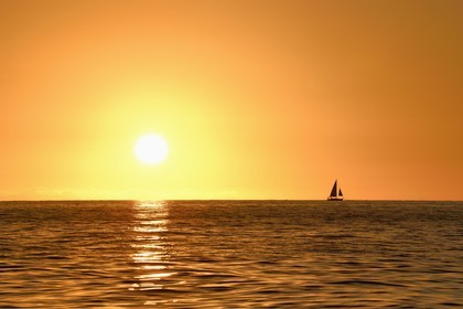 Caribbean, Dominica Island, sailboat at sunset on the west coast