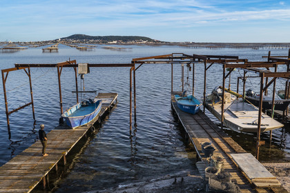France, Hérault, Bouzigues, village on the banks of the Etang de Thau and renowned for its oysters and shellfish, oyster farms, Mont Saint-Clair and Sète in the background (aerial view)