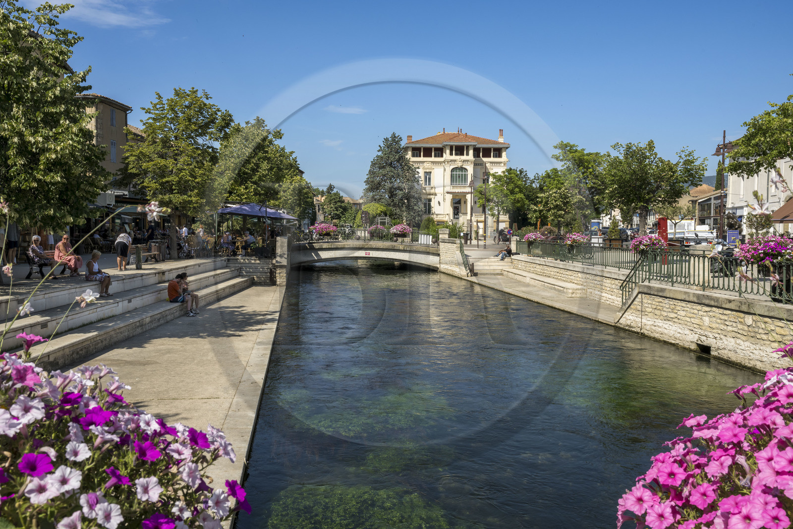 France, Vaucluse, L'Isle sur la Sorgue, one of the arms of the Sorgue river and the old Dumas castle built in 1880 which became the Caisse d'Epargne (bank)