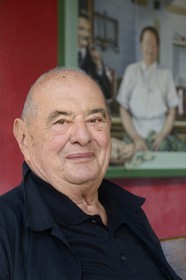 France, Rhone, Collonges au Mont d'Or, L'Auberge du Pont de Collonges Paul Bocuse Restaurant, three Michelin stars since 1965, famous French chef Paul Bocuse in front of the painted wall portraying French chef cook Eugenie Brazier called the mere Brazier