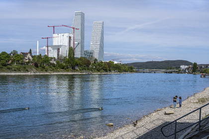 Switzerland, Basel, the Roche Towers, the tallest in Switzerland designed by the architects Herzog and de Meuron and the banks of the Rhine