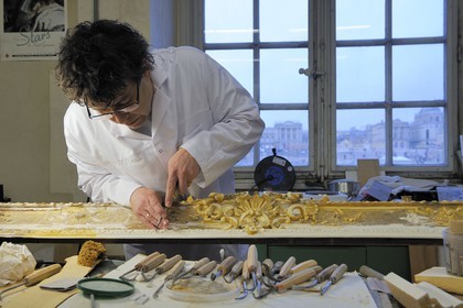 France, Yvelines, Chateau de Versailles, the castle restoration workshop, gilt workshop, Laurent Hissier working on a frame