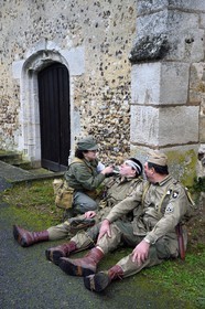 France, Eure, Chambray, Allied Reconstitution Group (US World War 2 and french Maquis historical reconstruction Association), reenactors in uniform of the 101st US Airborne Division resting in front of the church