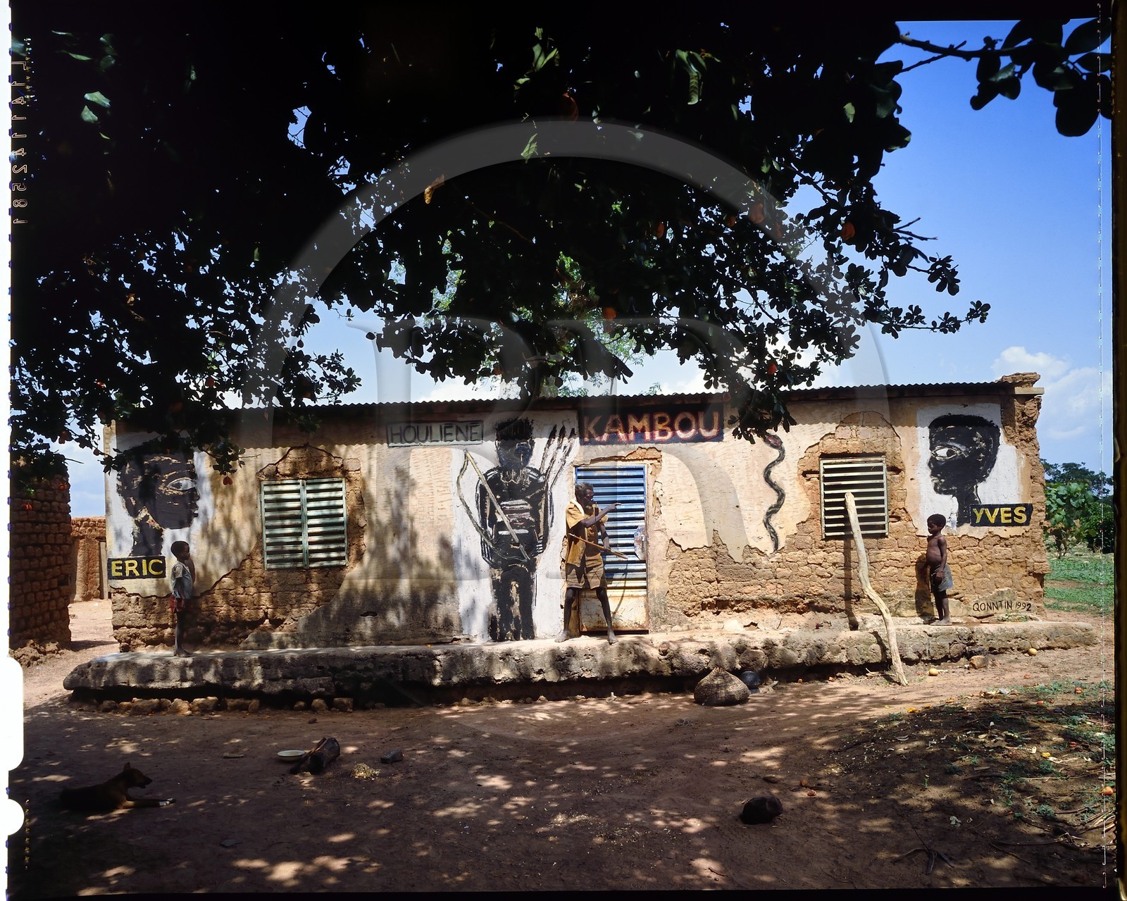 Burkina Faso, Poni province, Lobi land, Loropéni, Houliene Kambou with his little twin sons, wall painting by  artist Hans Bouman in 1992