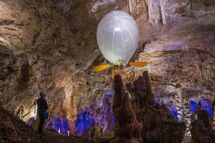 France, Gard, Mejannes-le-Clap, grotte de La Salamandre (Salamander cave), discovery of the cave in Aéroplume®, an individual dirigible balloon inflated with helium which allows you to fly away by flapping your wings