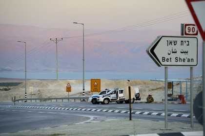 Israel, Beit HaArava junction, police patrol, the Dead Sea and the mountains of Jordan in the background