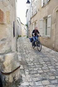 France, Charente (16), Cognac, quartier médiéval du vieux Cognac, cycliste faisant la véloroute La Flow Vélo dans la rue Henri Germain