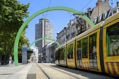 France, Haut Rhin, Mulhouse, tramway going throuth the Arches by artist Daniel Buren in Avenue du President Kennedy, Tour de l'Europe by architect Francois Spoerry in the background