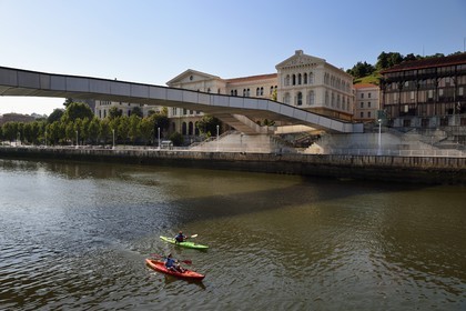 Spain, Basque Country, Biscay Province, Bilbao, Pedro Arrupe walkway over the Ria de Bilbao and the University of Deusto in the background