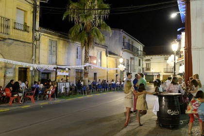 Spain, Extremadura, Guadalupe, restaurant terraces in summer in a village street