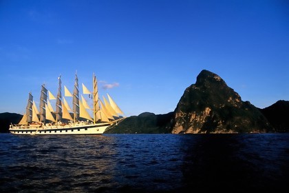 Caribbean sea, St Lucia island, the five masted ship SPV Royal Clipper with every sail set in front of the Piton of Soufriere
