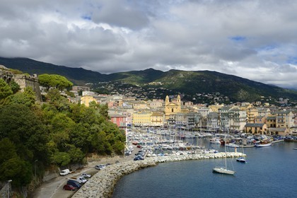 France, Haute Corse, Bastia, a tower from the Citadel left and the harbour overlooked by St Jean Baptiste Church on the right