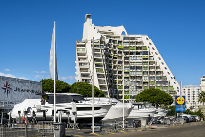 France, Herault, La Grande-Motte, labeled 20th century heritage, The Great Pyramid built in 1974 by the architects Jean Balladur and Jean-Bernard Tostivint, this flagship building for the port of the seaside resort dominates the whole city, forms a curved Y plan and houses a hotel and apartments