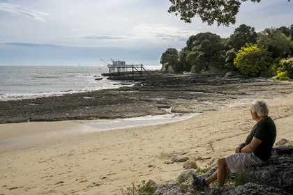 France, Charente-Maritime, Royan region, Saint Palais sur Mer, the Platin beach and traditional carrelet (fishing shack) in fishing huts in the background