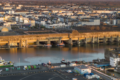 France, Loire Atlantique, Saint Nazaire, the former German submarine base built during the last world war border the dock of the harbour basin of Saint-Nazaire, the East lock and the fortified lock in the foreground on the right (aerial view)