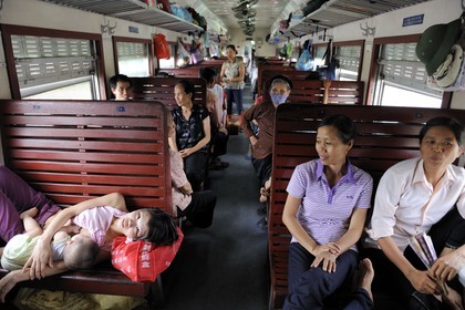 Vietnam, day train from Lao Cai to Hanoi, class Sat hard without climatisation, a mother breast-feeds her child