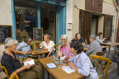 France, Herault, Sete, restaurant Fritto rue André Portes, Sète artist Topolino (Marc Combas) on the terrace with chef Marilou Fassanaro on the left and his brother Sète artist Robert Combas on the right in the background