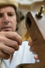 Argentina, Buenos Aires Province, San Antonio de Areco, Alejandro Alvarez plait leather parts of horses harness in his workshop