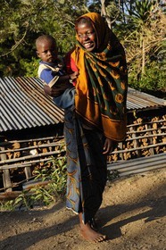 Tanzania, Morogoro district, Uluguru mountains, young girl carrying a child in a village around the former german refuge called Morningside