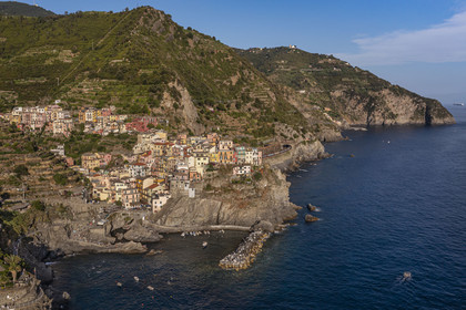 Italy, Liguria, Cinque Terre National Park listed as World Heritage by UNESCO, village of Manarola and its harbour (aerial view)