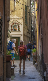 Italy, Liguria, Cinque Terre National Park listed as World Heritage by UNESCO, hiker crossing the village of Vernazza