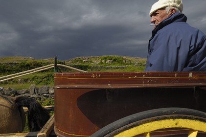 Republic of Ireland, County Galway, Aran Islands, Inishmore, Aran inhabitant on a barouche