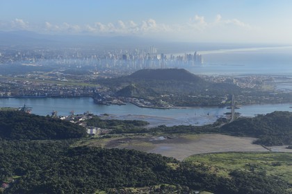 Panama, Panama City skyscrapers and the Bridge of the Americas (Puente de las Americas) over the Panama Canal in the foreground (aerial view)