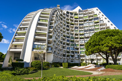 France, Herault, La Grande-Motte, labeled 20th century heritage, The Great Pyramid built in 1974 by the architects Jean Balladur and Jean-Bernard Tostivint, this flagship building for the port of the seaside resort dominates the whole city, forms a curved Y plan and houses a hotel and apartments