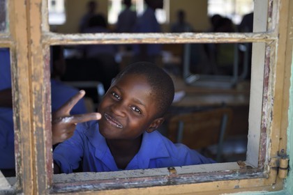 Namibia, Erongo region, Damaraland, the Spitzkoppe in the Namib Desert, Katora Primary School, boy in the grade 4 classroom (around 11 years)