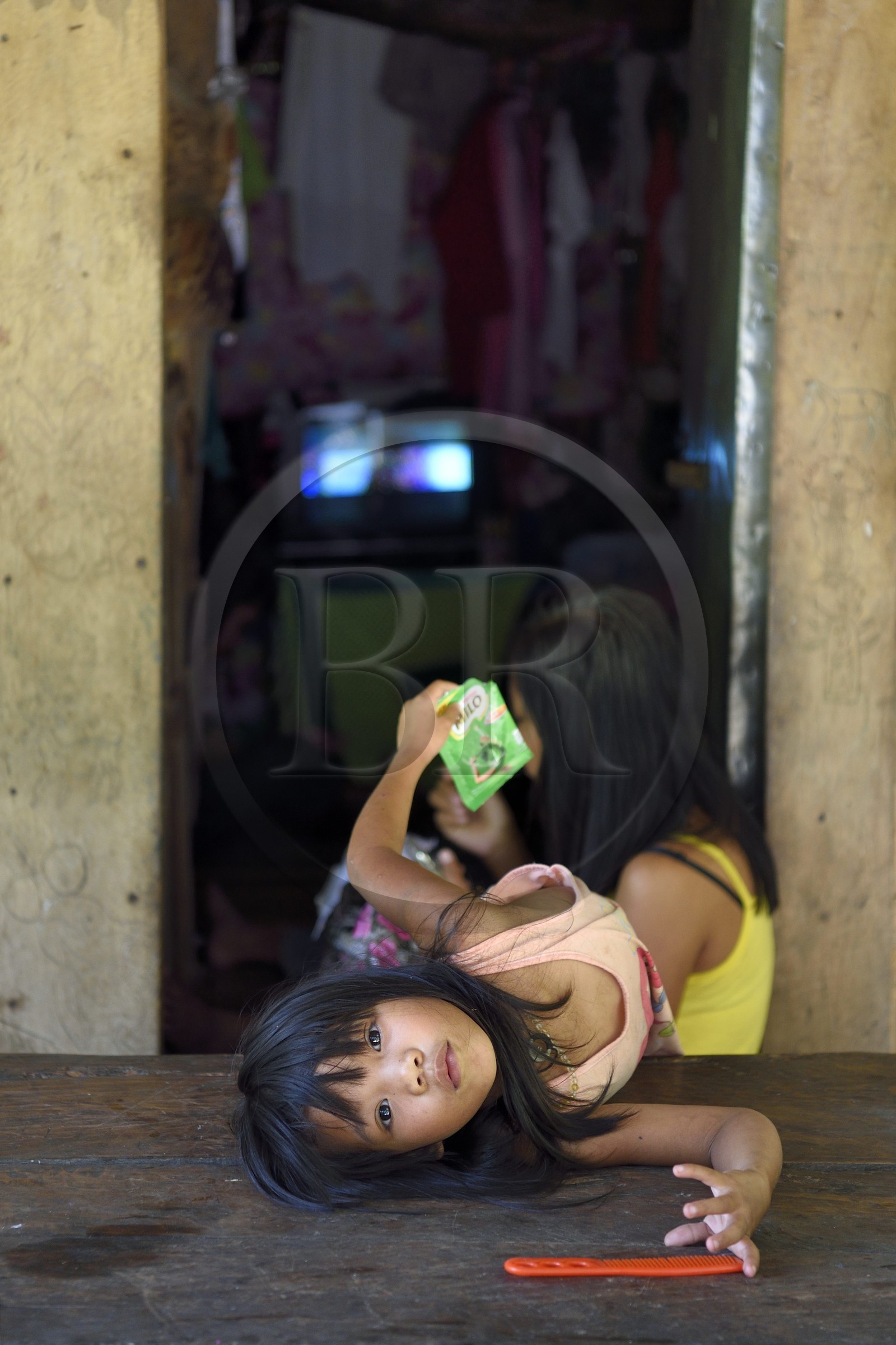 Philippines, Ifugao province, village of Batad, little girl in front of the family home