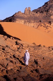 Libya, region of the desert, the Fezzan (Sahara), Tadrart Akacus, Tuareg walking in dunes and sandstone