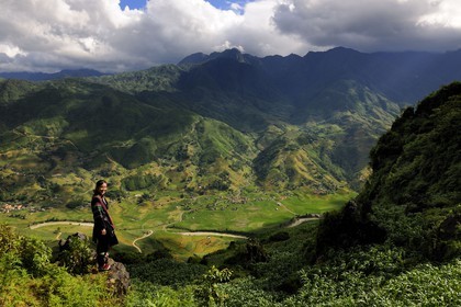 Vietnam, Lao Cai province, Sapa district, young woman from the Black Hmong minority group overlooking her valley Hau Thao