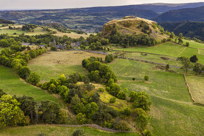 France, Cantal, Parc Naturel Régional des Volcans d'Auvergne (regional nature park of Auvergne volcanoes), Chastel-sur-Murat, 12th century perched on a promontory Saint Antoine (Saint Anthony) Chapel, hickers on the Way of St. James to Santiago de Compostela by Via Arverna (aerial view)