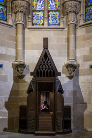 Spain, Catalonia, Barcelona, Eixample district, Sagrada Familia basilica by Catalan modernist architect Antoni Gaudi, listed as a UNESCO World Heritage Site, the neo-Gothic style crypt serves as a parish church, furniture and liturgical objects designed by Gaudi, priest Joby Sebastian Kappiparambil in the confessional